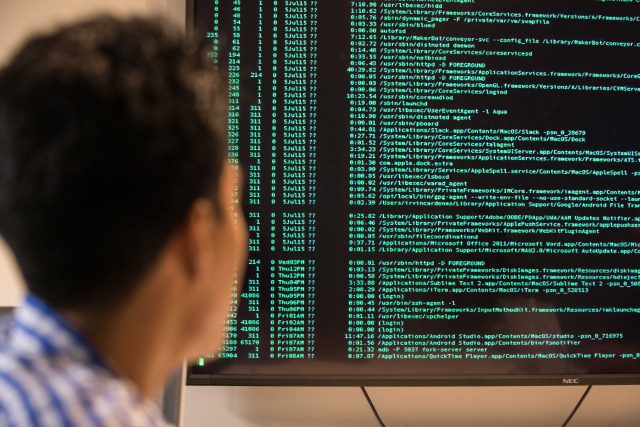FIU Student viewing terminal information on big screen.