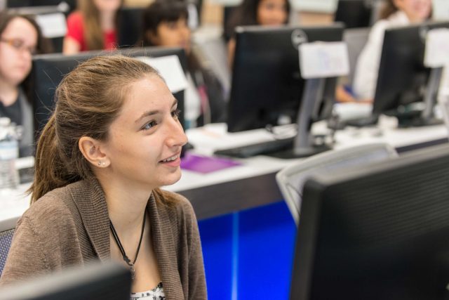 FIU Student listening in lecture.