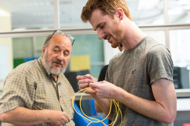 Professor Robinson and student in Hardware Lab.